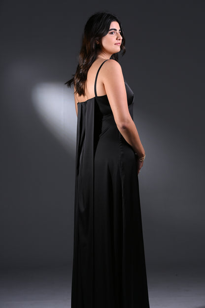 Woman wearing a black dress against a dark background